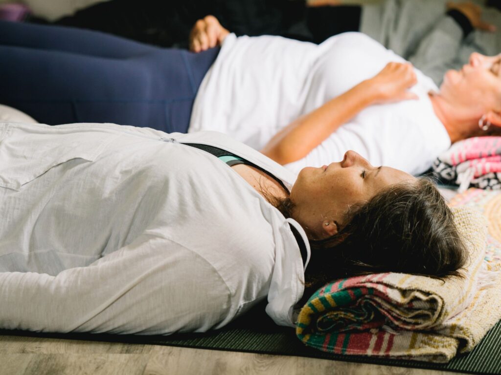 women practicing nature inspired yoga nidra during a yoga class