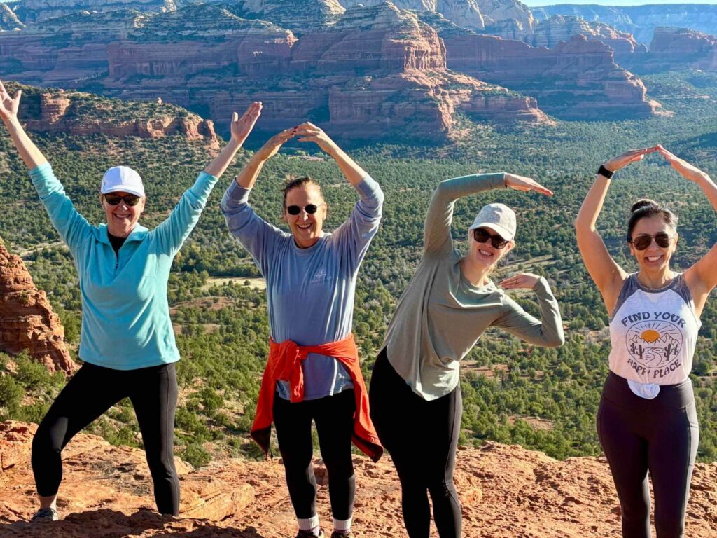 group of women spelling YOGA with their bodies during a women's retreat in Sedona