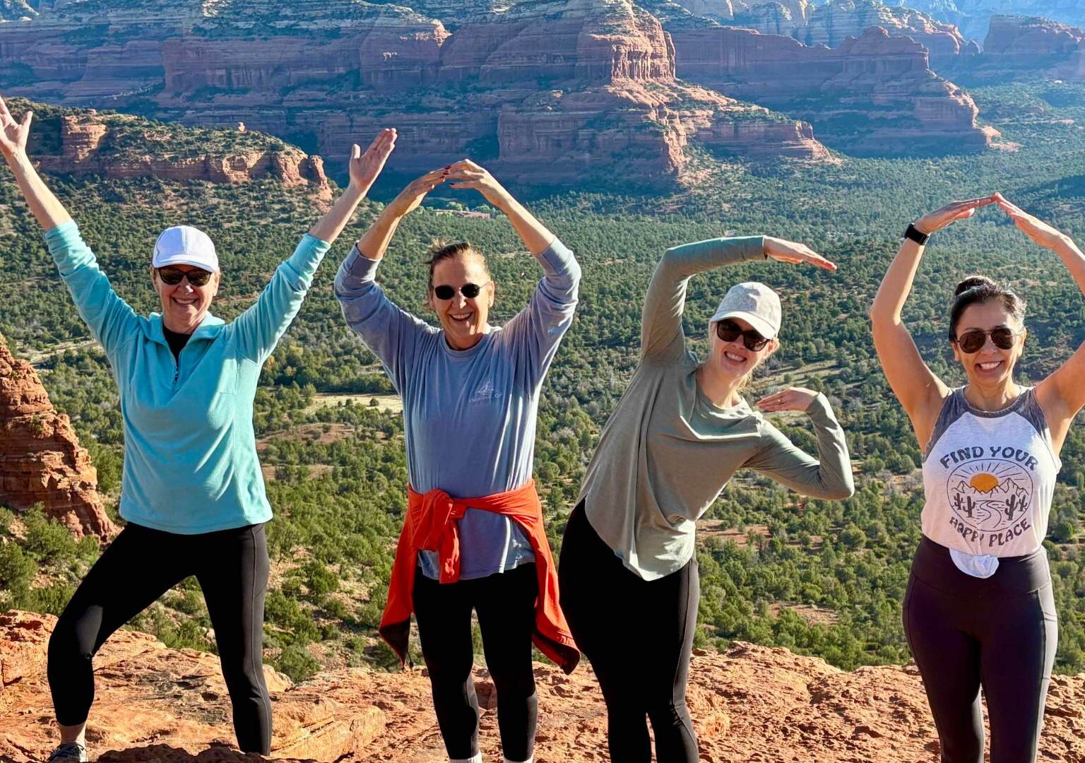 group of women spelling YOGA with their bodies during a women's retreat in Sedona