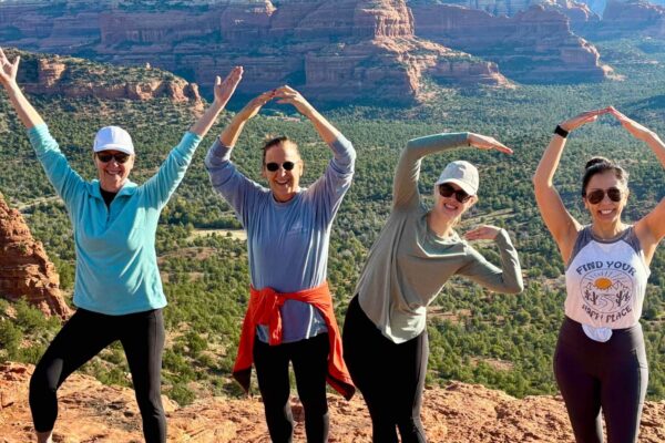 group of women spelling YOGA with their bodies during a women's retreat in Sedona