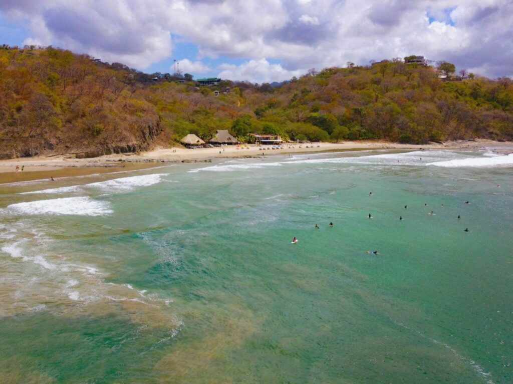 drone shot of playa maderas during women's yoga teacher training in nicaragua