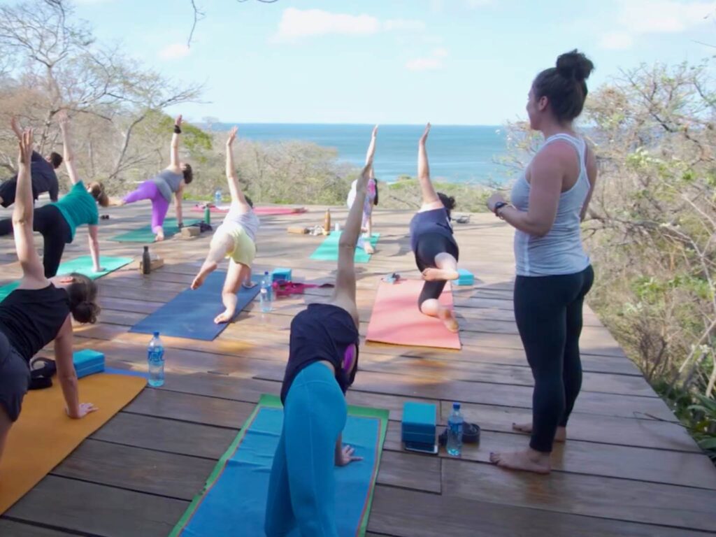 Autumn teaching a yoga class overlooking the ocean during a yoga teacher training