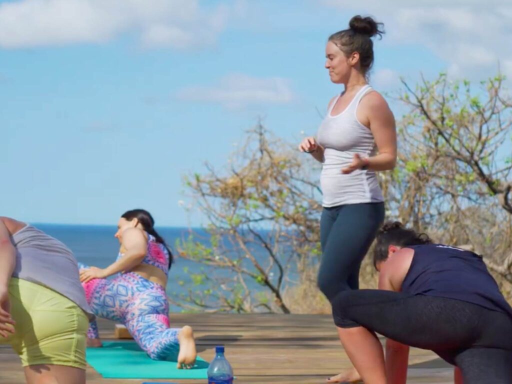 yoga class overlooking the ocean during yoga teacher training