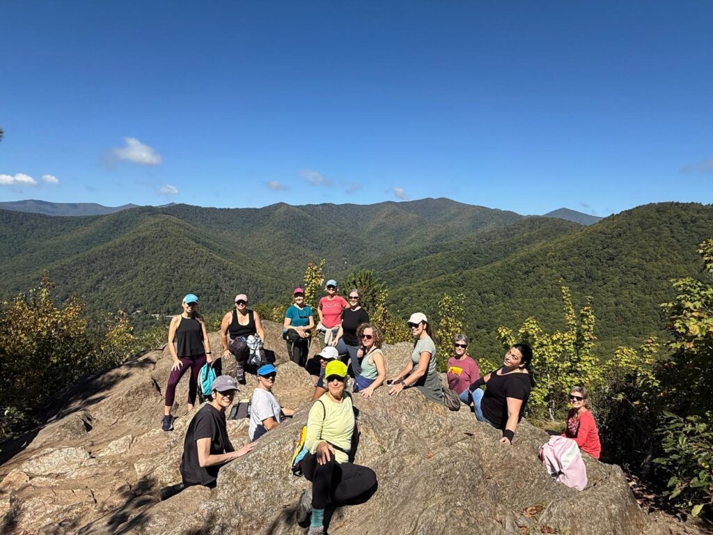 group of women on mountain top trail near Asheville