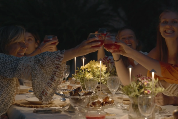 women enjoying a long dinner with a celebratory toast during a women's yoga retreat in Mallorca