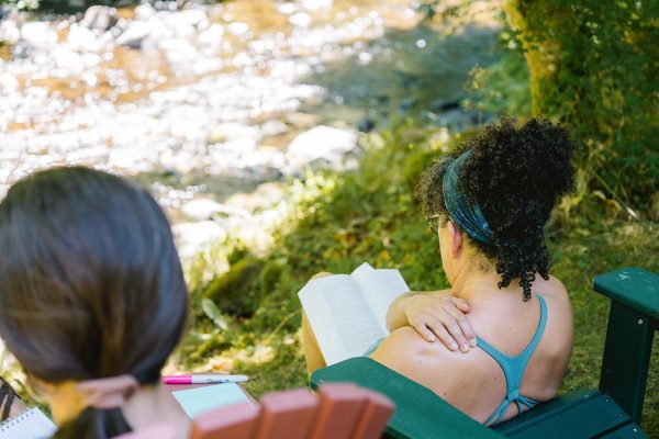 yoga teacher training students reading their materials at yoga teacher training in Oregon